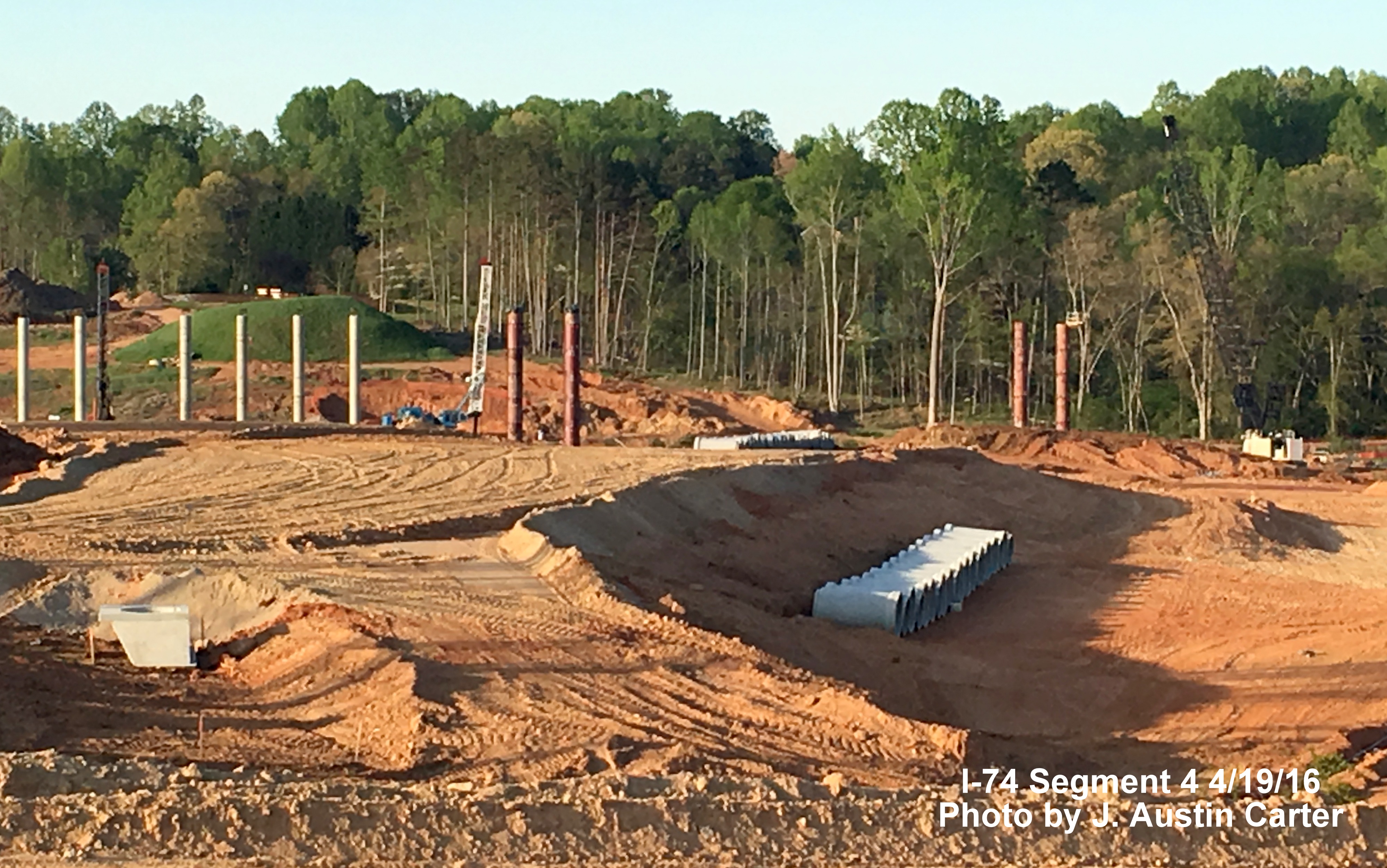 Image of bridge support and culvert pipes being placed north of Bus. 40 for new Northern Beltway/I-40 interchange, by J. Austin Carter