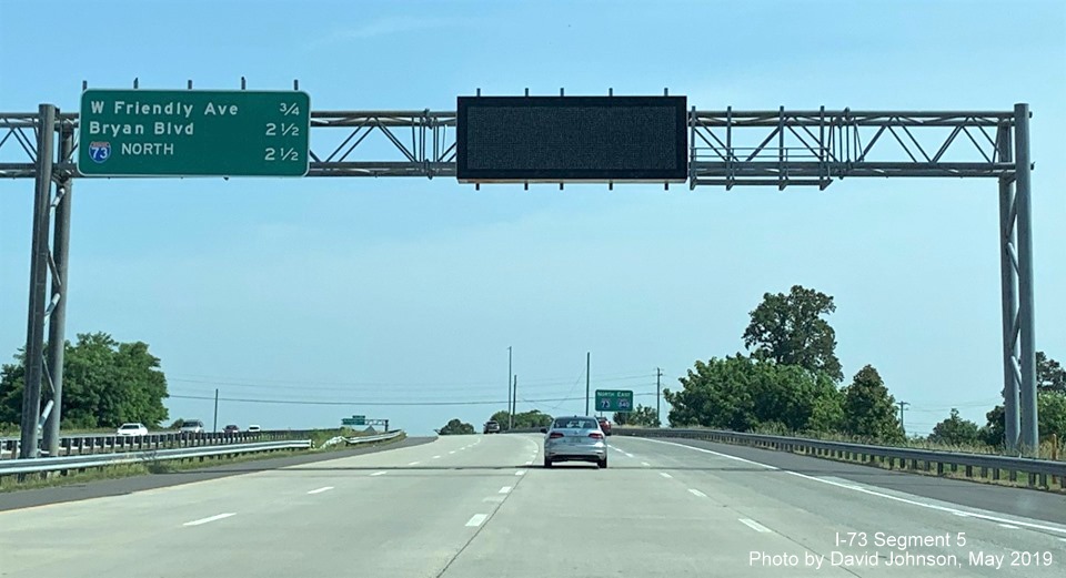 Image of overhead exit distance sign on gantry with VMS on I-73 North/I-840 East Greensboro Loop, by David Johnson