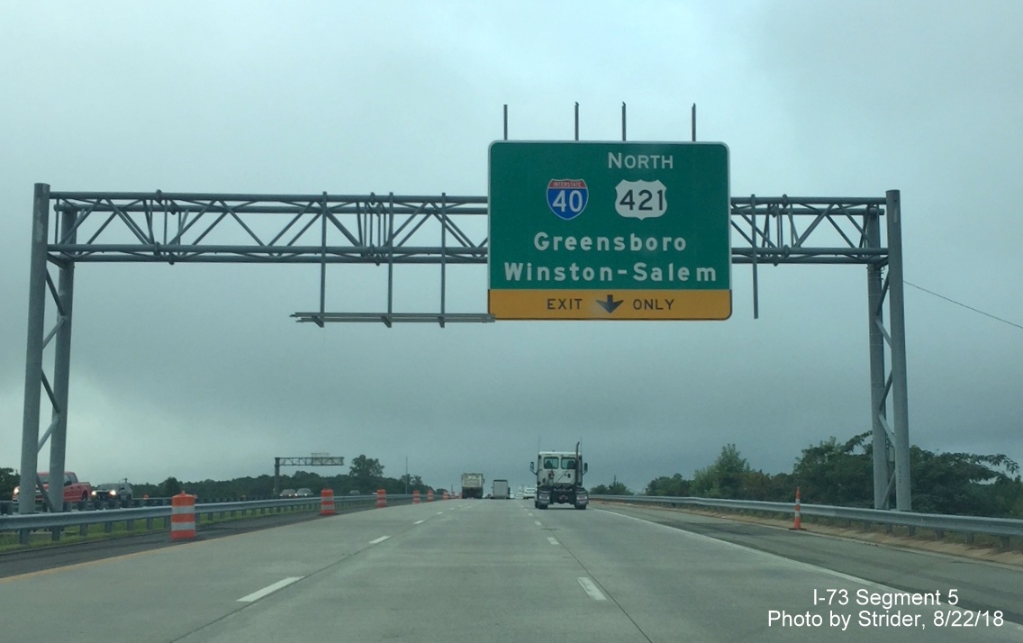 Image of I-40 interchange sign with old exit tab removed to allow for new exit number signage on I-73 South in Greensboro, by Strider