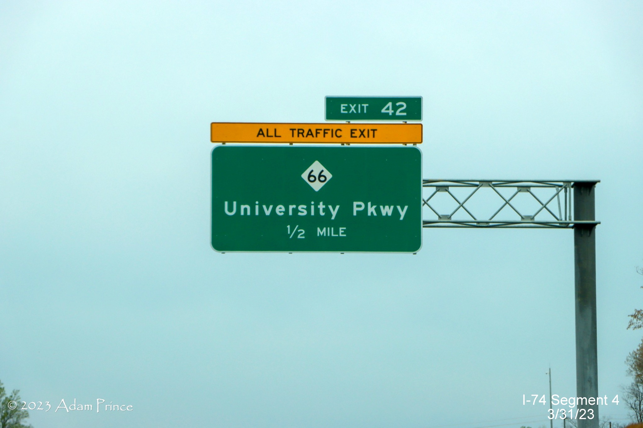 Image of 1/2 Mile advance sign for NC 66/University Parkway exit on NC 74 (Future I-74) West/Winston-Salem 
        Northern Beltway, Adam Prince, March 2023