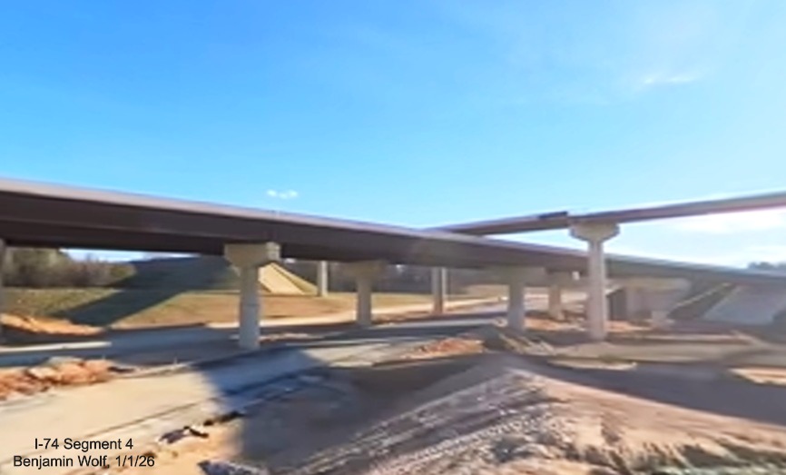 Image of flyover ramps crossing each other looking south over future I-74 Beltway
lanes in Winston-Salem Northern Beltway interchange project work zone, screen grab from Benjamin Wolf video, January 2026