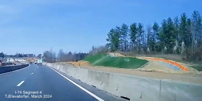 Image of still unpaved future ramp from US 52 (Future I-285) North to NC 74 (Future I-74) 
       East/Winston-Salem Northern Beltway, screen grab from TJElevatorfan video, March 2024