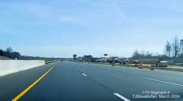 Image of traffic at the start of NC 74 (Future I-74) East/Winston-Salem Northern Beltway
        after the split from US 52 South using future I-74 westbound lanes, the future east lanes are being prepared for paving, screen grab         from TJElevatorfan video, March 2024