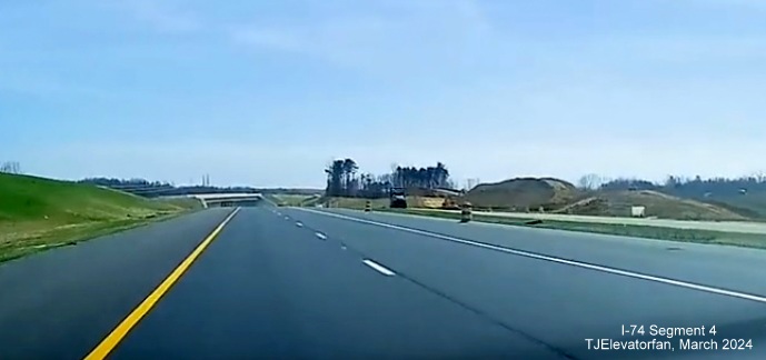 Image of current NC 74 (Future I-74) East lanes heading towards US 52 North bridge with future lanes 
       being prepared for paving on the right, screen grab from TJElevatorfan video, March 2024