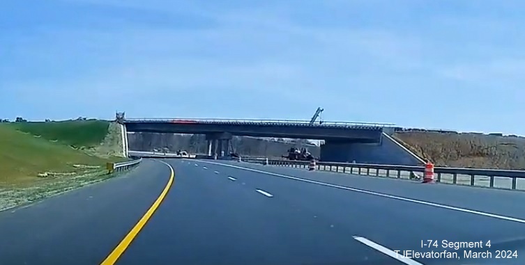 Image of NC 74 (Future I-74) East/Winston-Salem Northern Beltway heading under incomplete
       future ramp from Beltway west to US 52, screen grab from TJElevatorfan video, March 2024