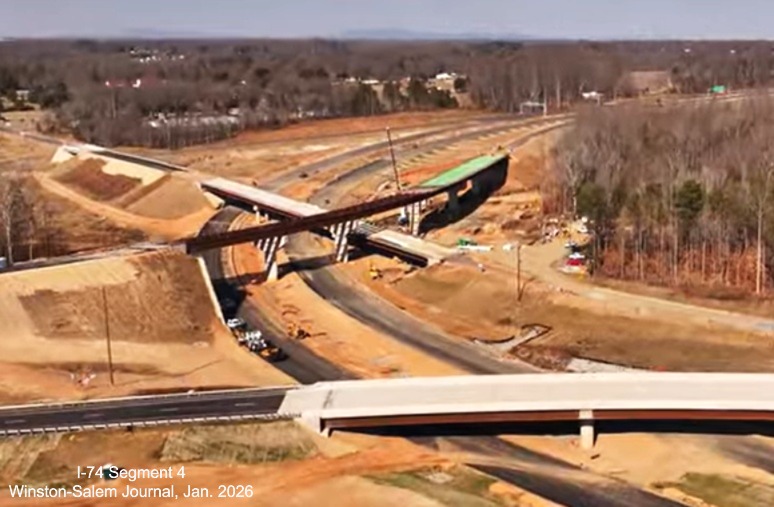 Image over Beltway flyover ramps under construction at I-74 as part of the Winston-
Salem Northern Beltway interchange project, screen grab from Winston-Salem Journal video, January 2026