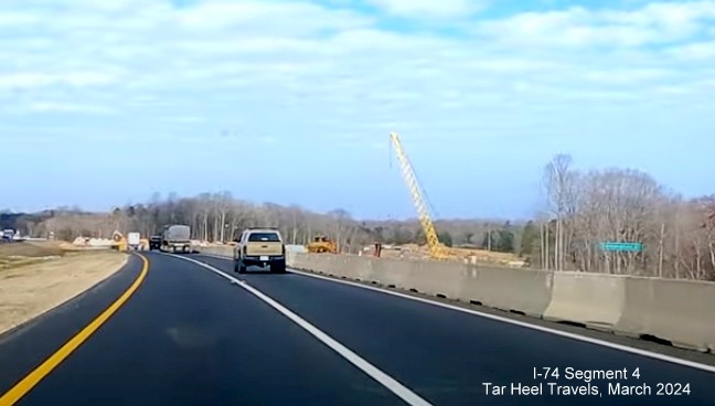 Image of future Beltway lanes seen from I-74 West in interchange construction area, from 
        video by TarHeel Travels, March 2024