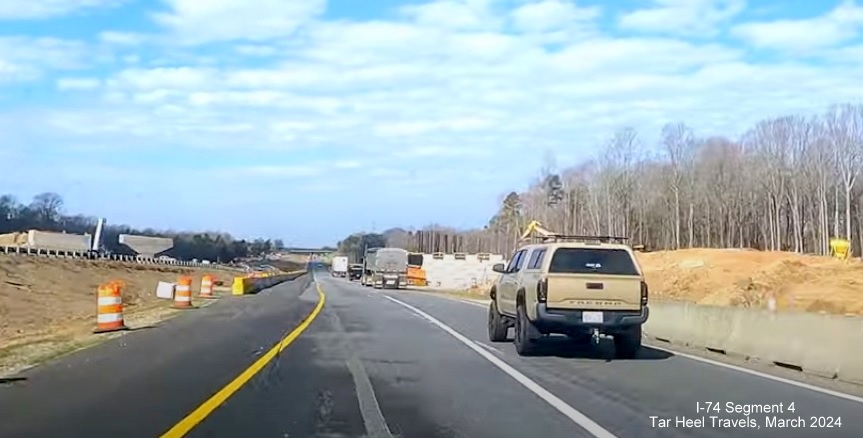 Image of ramp structures being built for Winston-Salem Northern Beltway interchange over current
        I-74, from video by TarHeel Travels, March 2024