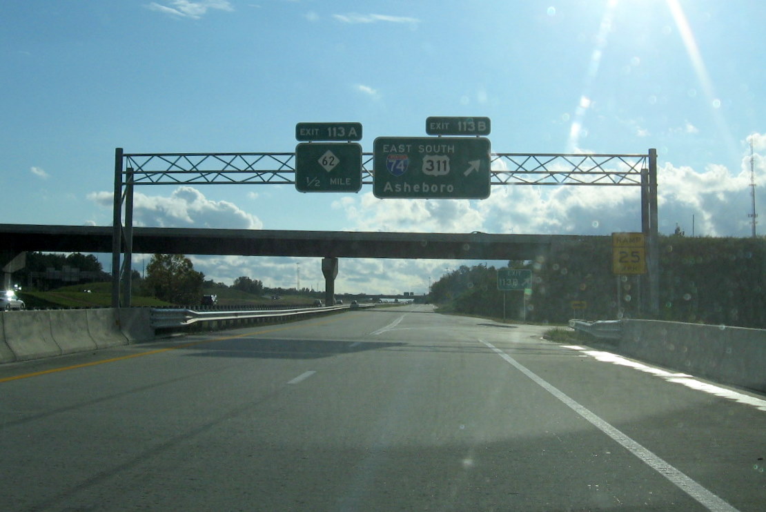 Photo of signage at I-74 interchange off-ramp from I-85 South at sunset in 
Oct. 2011