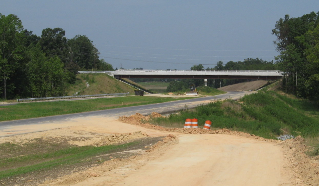 Photo of Kersey Valley Rd Bridge showing additional guardrails and construction 
progress on the I-74 freeway, July 2010