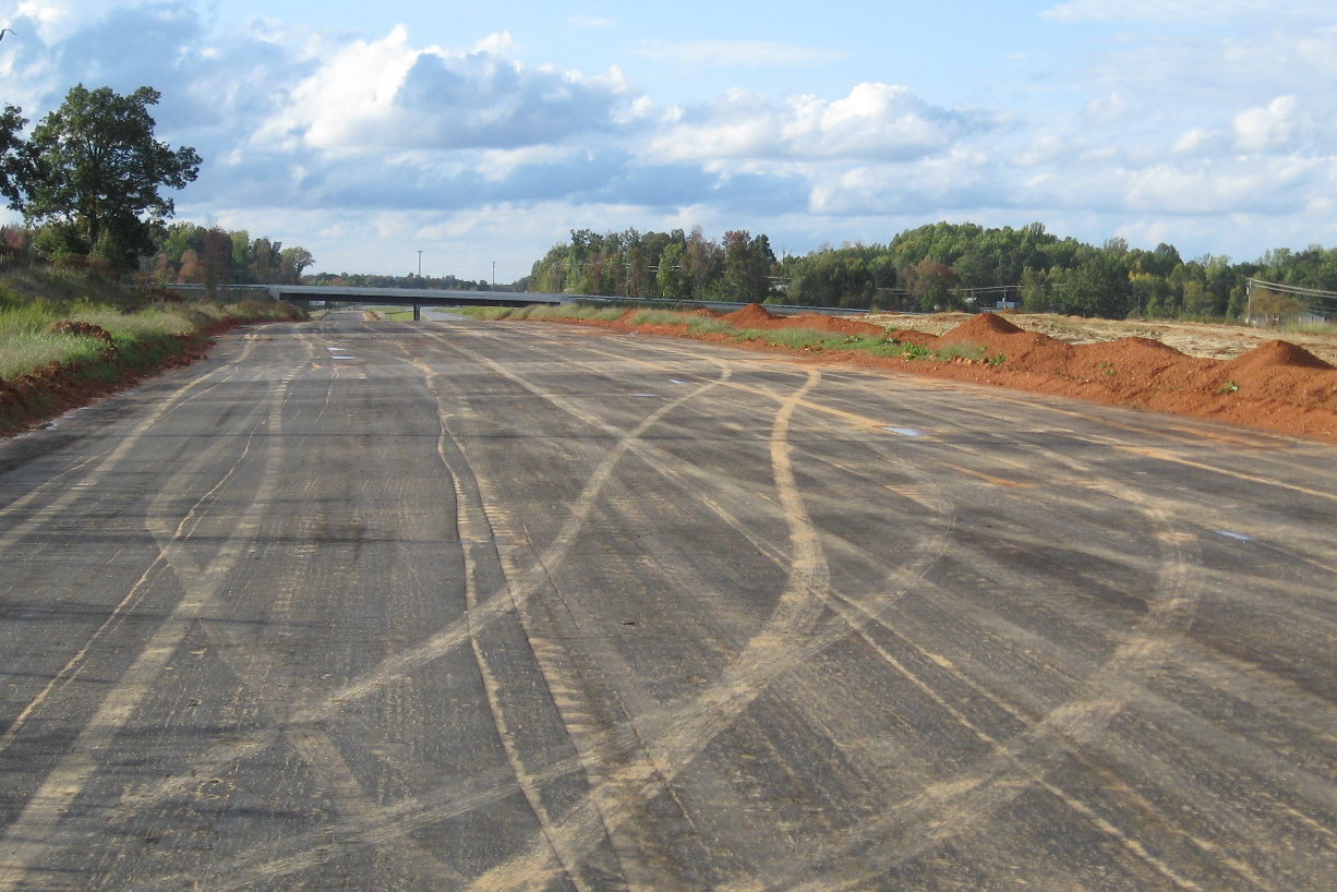 Photo of view looking back from where Spencer Road had cut across I-74
roadbed towards the Cedar Square Rd interchange, Oct. 2011