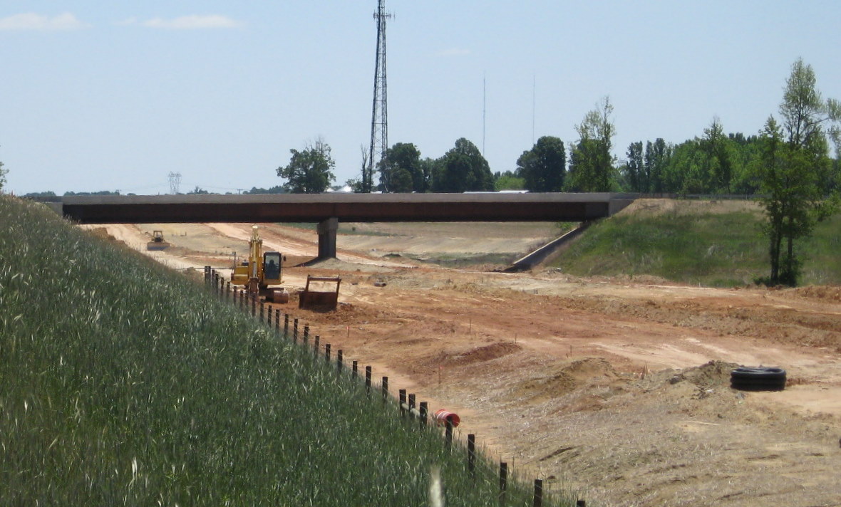 Photo of progress in grading future road surface under open Cedar Square Rd 
bridge in May 2010