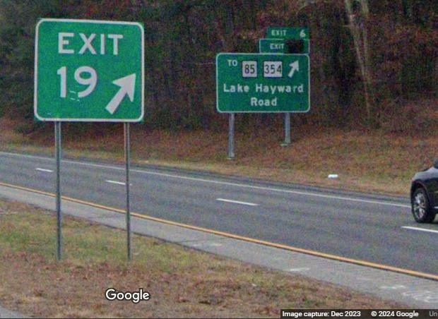 Image of first new exit sign on CT 11 showing covered future milepost based exit number from CT 2 East in Colchester. Google Maps Street View, December 2023