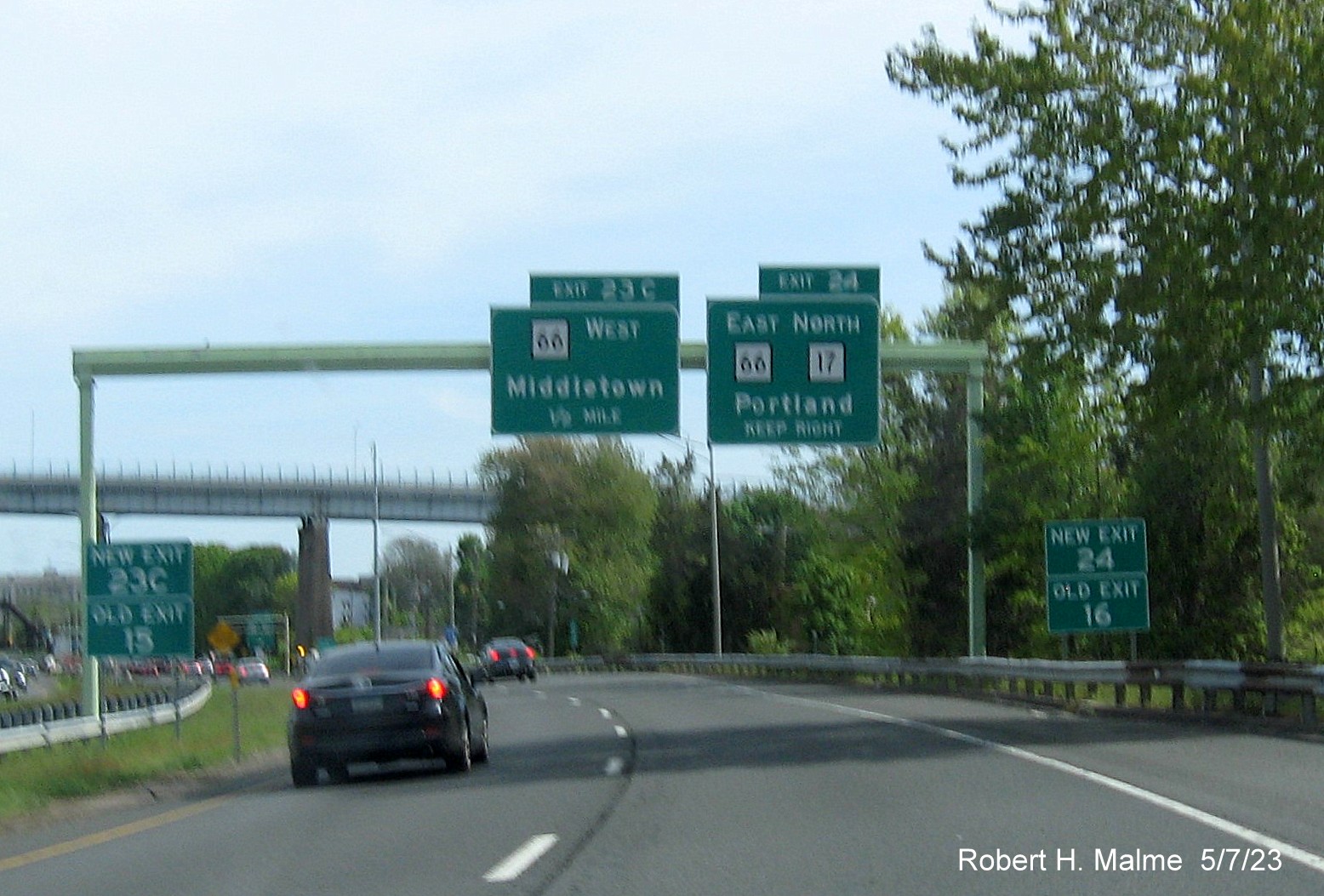 Image of overhead advance signage for East CT 66/North CT 17 and CT 66 West exits with new milepost based exit number and Old Exit 17 sign attached below on CT 9 South in Middletown