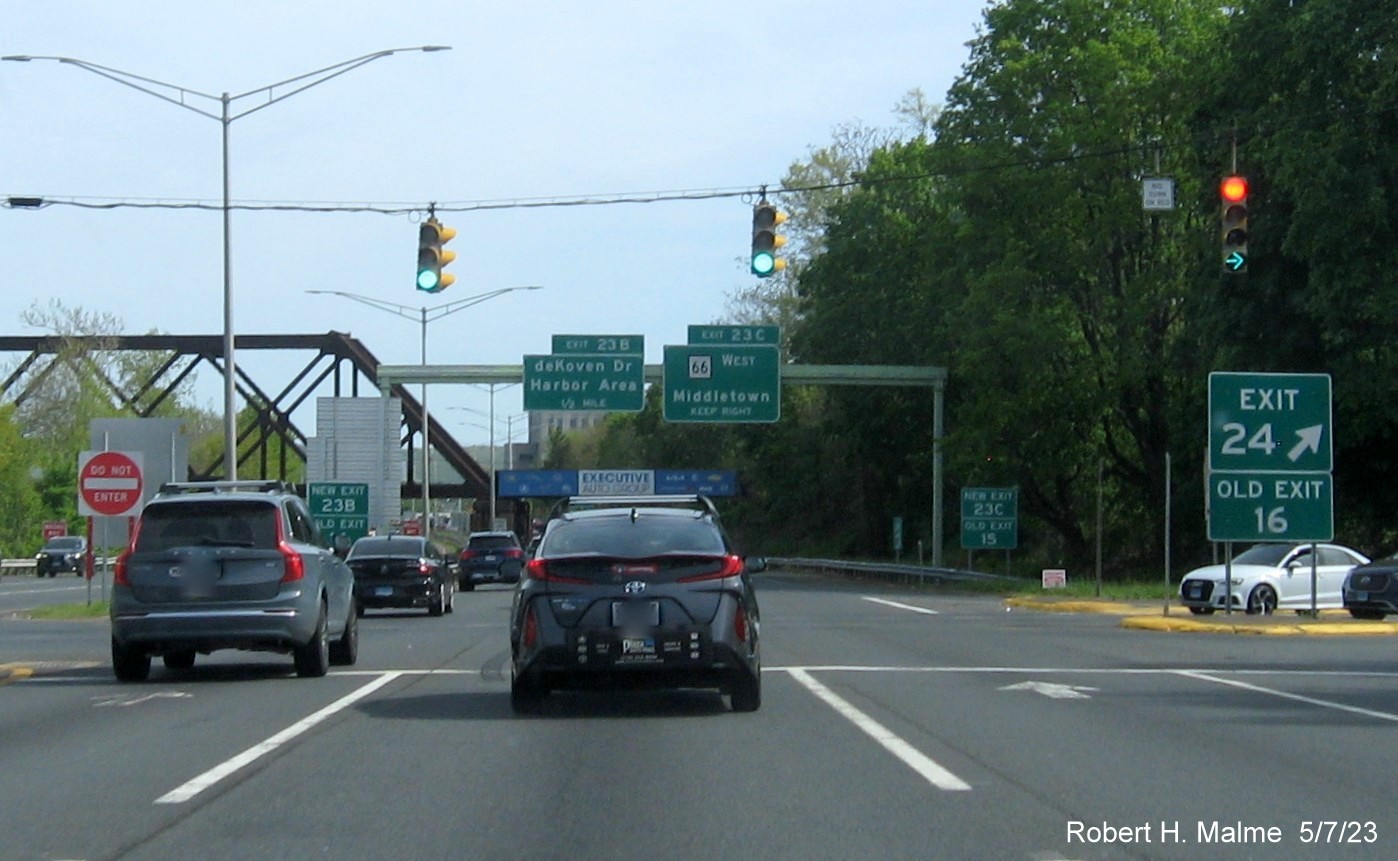Image of gore sign for CT 66 East/CT 17 North signalized exit with new milepost based exit number and Old Exit 16 sign attached below on CT 9 South in Middletown, May 2023