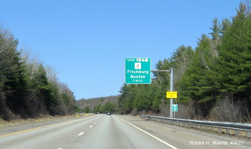 Image of 1 Mile advance overhead sign for MA 2 exit with new milepost based exit numbers and yellow Old Exits 8 A-B sign on support post on I-190 North in Leominster, April 2021