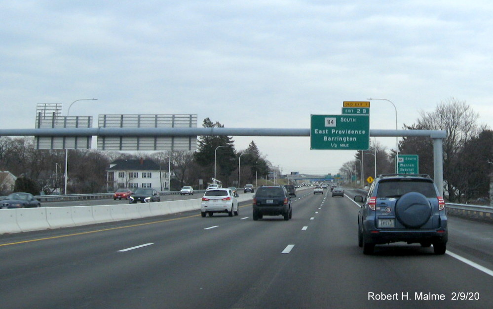 Image of overhead 1/2 mile advance sign with new milepost based exit number and yellow old exit tab for RI 114 South exit on I-195 East in East Providence