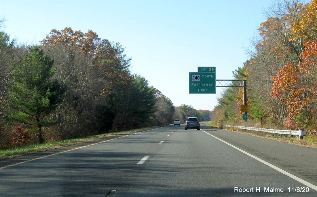 Image of 1-mile advance overhead sign for MA 240 South exit with new milepost based exit number and yellow old exit number sign on support on I-195 West in Fairhaven, November 2020