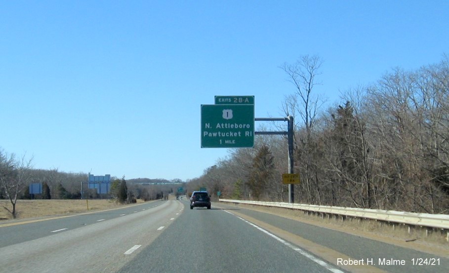 Image of 1-mile advance overhead sign for US 1 exits with new milepost based exit numbers and yellow old 
                                      exit numbers sign on support post on I-295 South in North Attleborough, January 2021