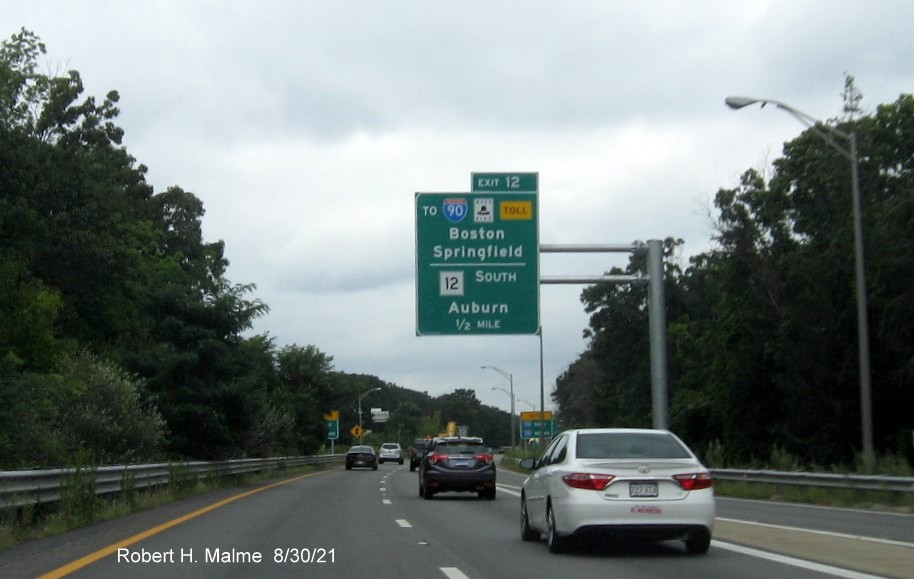 Image of 1/2 mile advance overhead sign for I-90/Massachusetts Turnpike and MA 12 exit with new milepost based exit number and yellow Old Exit 7 advisory sign on right support on I-395 North in Auburn, August 2021