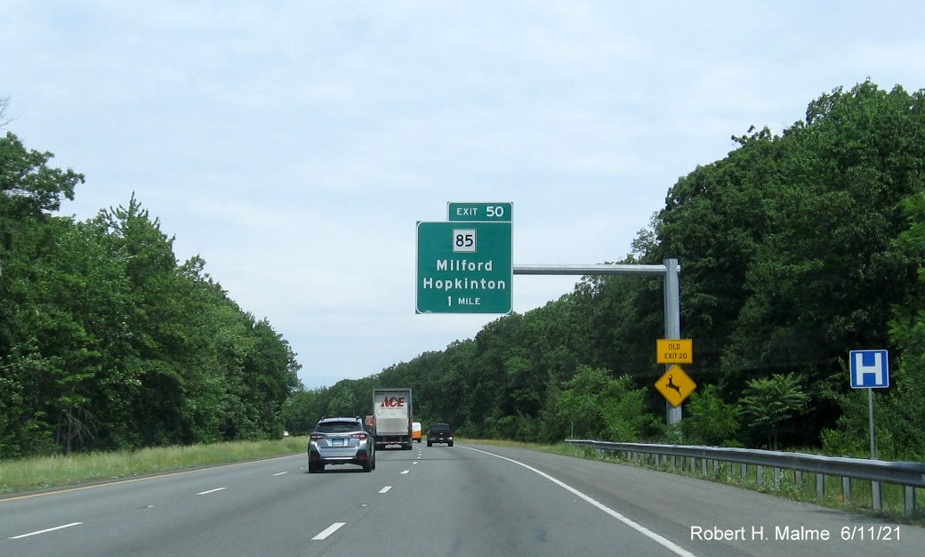 Image of 1 mile advance overhead sign for MA 85 exit with new milepost based exit number and yellow Old Exit 20 advisory sign on support on I-495 North in Milford, June 2021