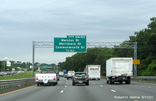 Image of 1 mile advance sign for Marston Street, Merrimack Street and Commonwealth Drive exits with new milepost based exit numbers and yellow Old Exits 44-45 advisory sign on right support on I-495 North in Lawrence, June 2021