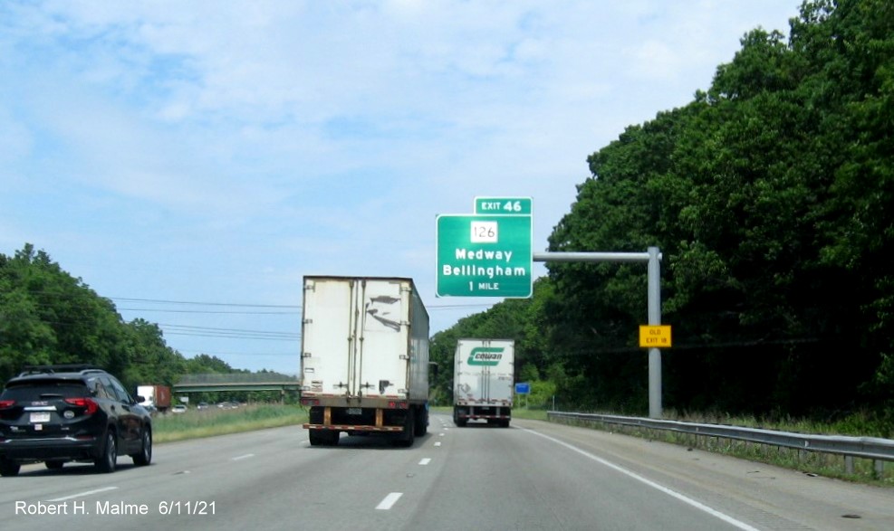 Image of 1 mile advance overhead sign for MA 126 exit with new milepost based exit number and yellow Old Exit 18 advisory sign on support on I-495 North in Bellingham, June 2021