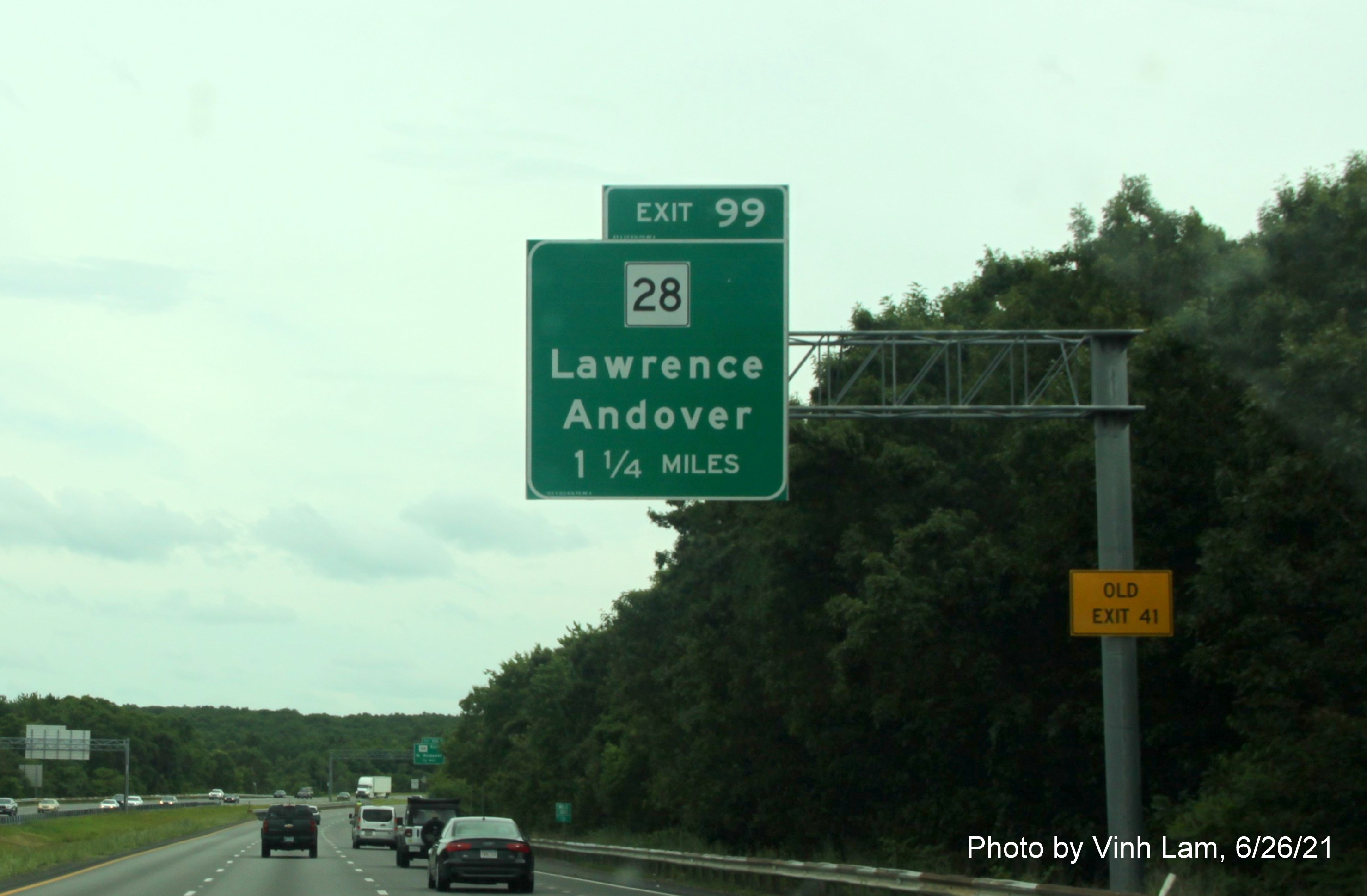 Image of 1 mile advance overhead sign for MA 28 exit with new milepost based exit number and yellow Old Exit 41 advisory sign on support on I-495 South in North Andover, by Vinh Lam, June 2021