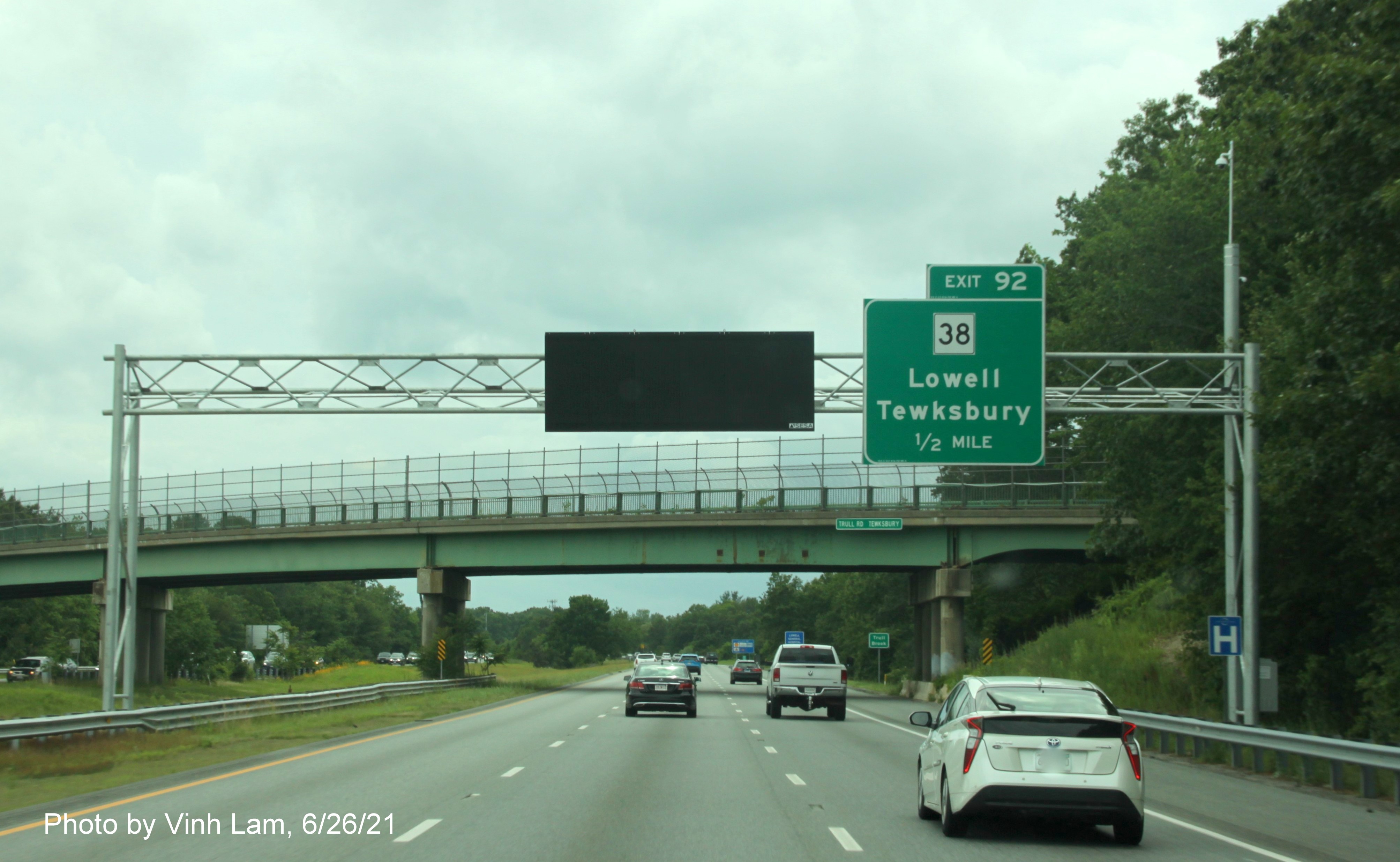 Image of 1/2 mile advance overhead sign for MA 38 exit with new milepost based exit number on I-495 South in Tewksbury, by Vinh Lam, June 2021