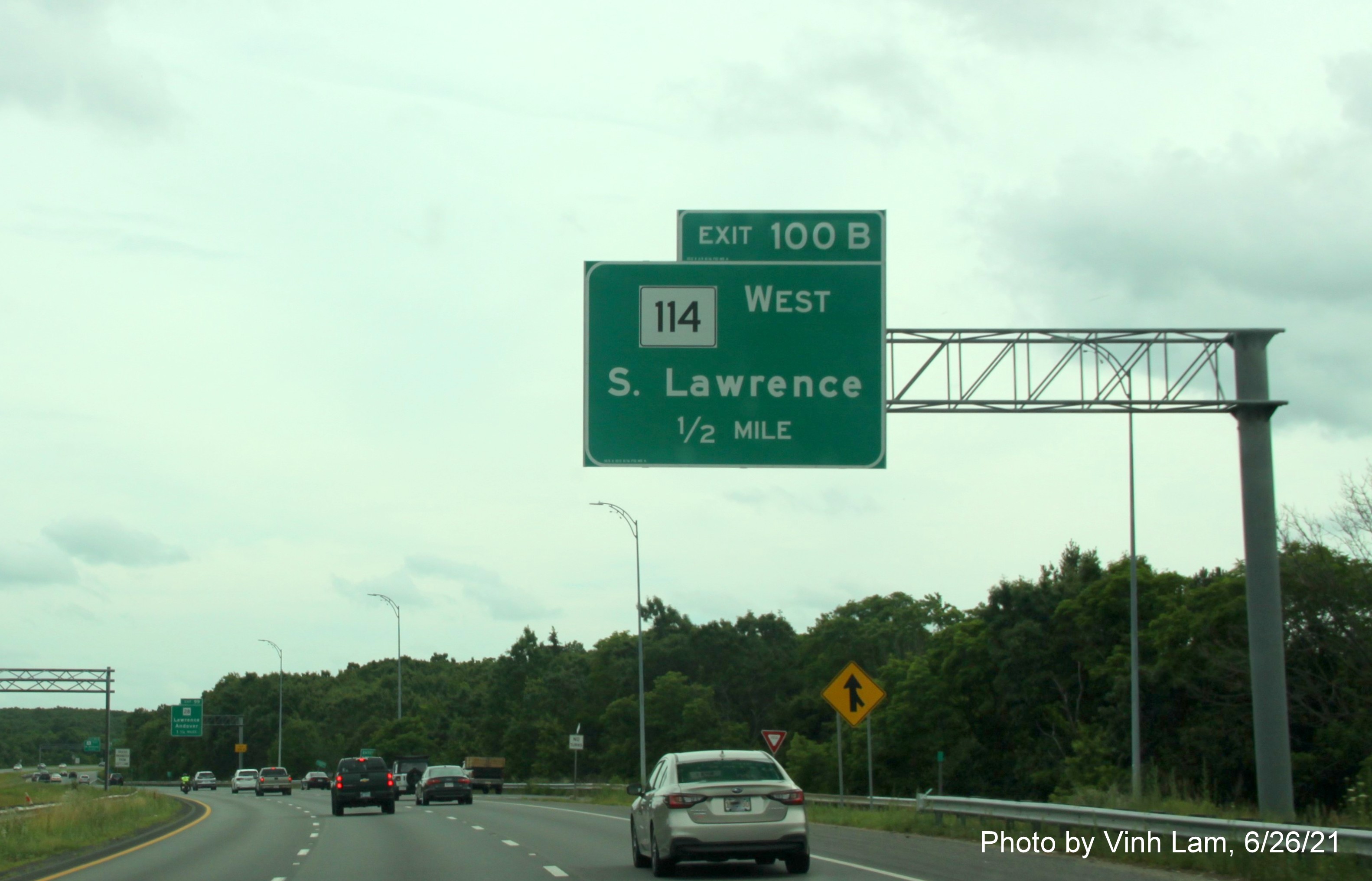 Image of 1/2 mile advance overhead sign for MA 114 exits with new milepost exit numbers on I-495 South in North Andover, by Vinh Lam, June 2021