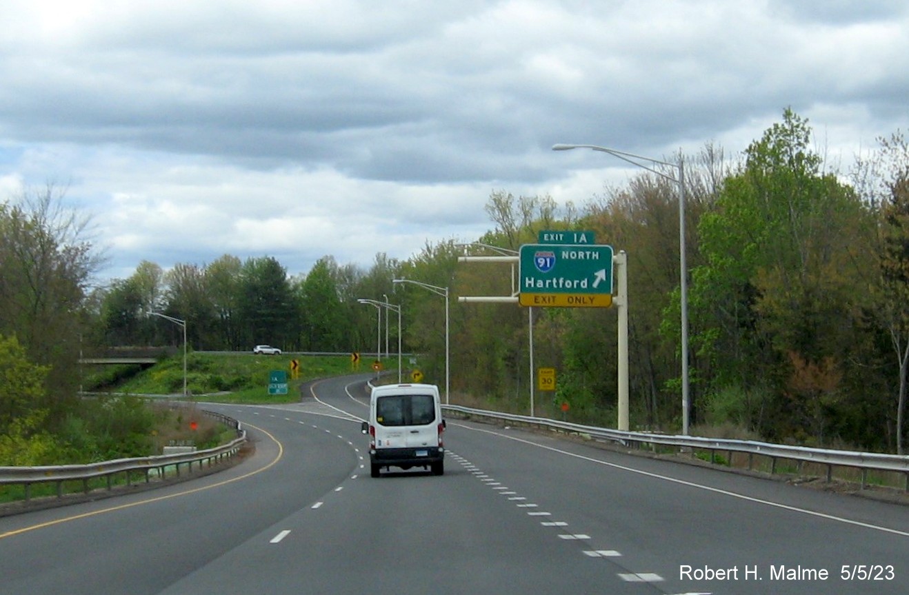 Image of overhead ramp sign for I-91 North exit with new milepost based exit number at beginning of I-691 in Meriden CT, May 2023