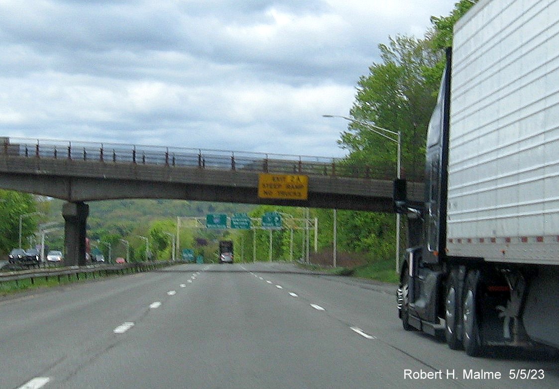 Image of bridge mounted yellow advisory sign for US 5 exit ramp with new milepost based exit number on I-691 West in Meriden CT, May 2023