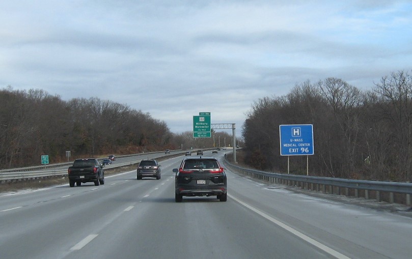 Image of auxiliary sign for MA 122 exit with new milepost based exit number on I-90/Mass Pike East in Millbury, January 2021