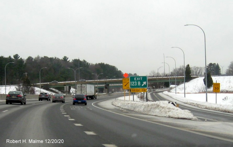 Image of gore sign for To MA 30 exit with new milepost based exit number and yellow old exit number tab below on I-90/MassPike West in Weston, December 2020