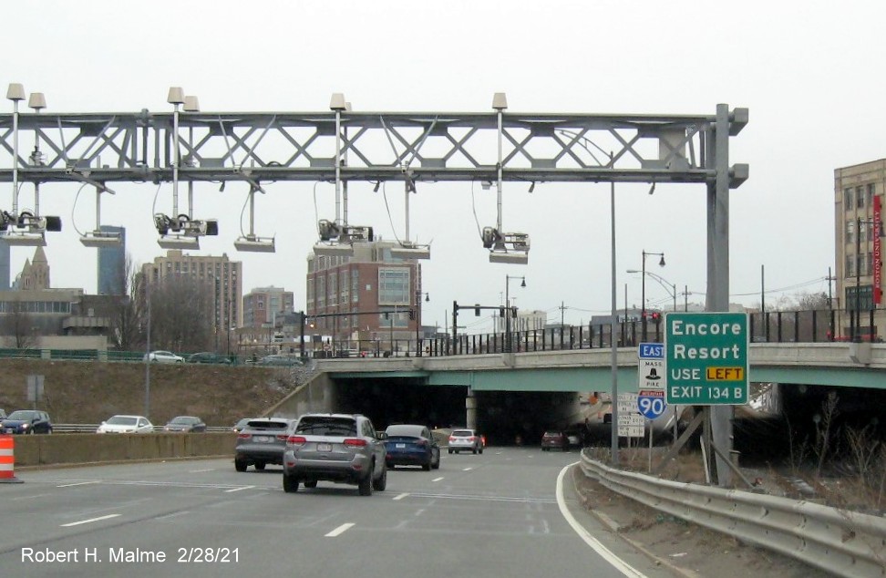 Image of small auxiliary sign for I-93 North exit with new milepost based exit number on I-90/Mass Pike East in Boston, February 2021