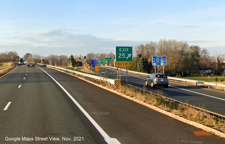 Image of gore sign for MA 9 exit with new milepost based exit number and yellow Old Exit 19 sign attached below on I-91 North in Amherst, Google Maps Street View image, November 2021
