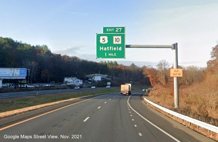 Image of 1 mile advance overhead sign for US 5/MA 10 exit with new milepost based exit number and yellow Old Exit 21 advisory sign on support on I-91 North in Hatfield, Google Maps Street View image, November 2021