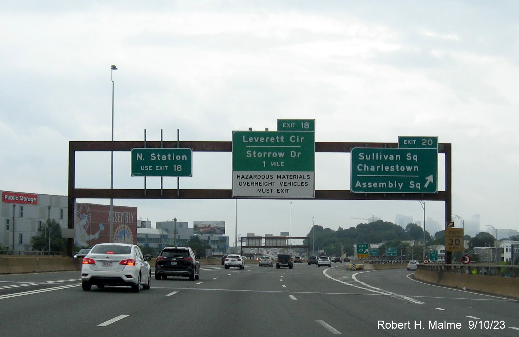 Image of overhead signs at ramp to Sullivan Square exit with new Storrow Drive 1 mile advance with MA 3 and MA 28 shields removed, September 2023