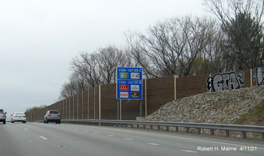 Image of auxiliary sign for Highland Avenue/Kendrick Street exits with new milepost based 
                                            exit numbers on I-95/MA 128 South in Needham, April 2021
