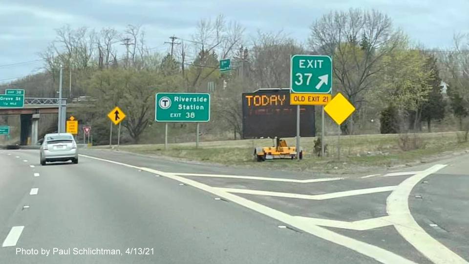 Image of gore sign for MA 16 exit with new milepost based exit number and yellow Old Exit 21 sign attached below on I-95/MA 128 North in Newton, by Paul Schlichtman, April 2021
