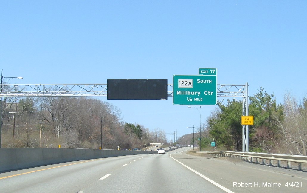Image of 1/4 Mile advance exit only overhead sign for MA 122A South exit with new milepost based exit number and yellow Old Exit 9 advisory sign on support on MA 146 North in Millbury, April 2021
