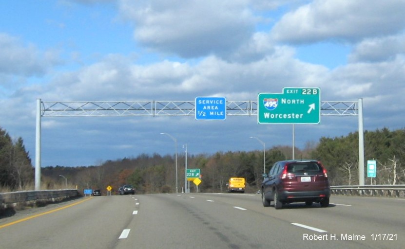 Image of overhead ramp sign for I-495 South exit with new milepost based exit number and gore sign with new number and yellow Old Exit 14B sign below on MA 24 North in Raynham, January 2021
