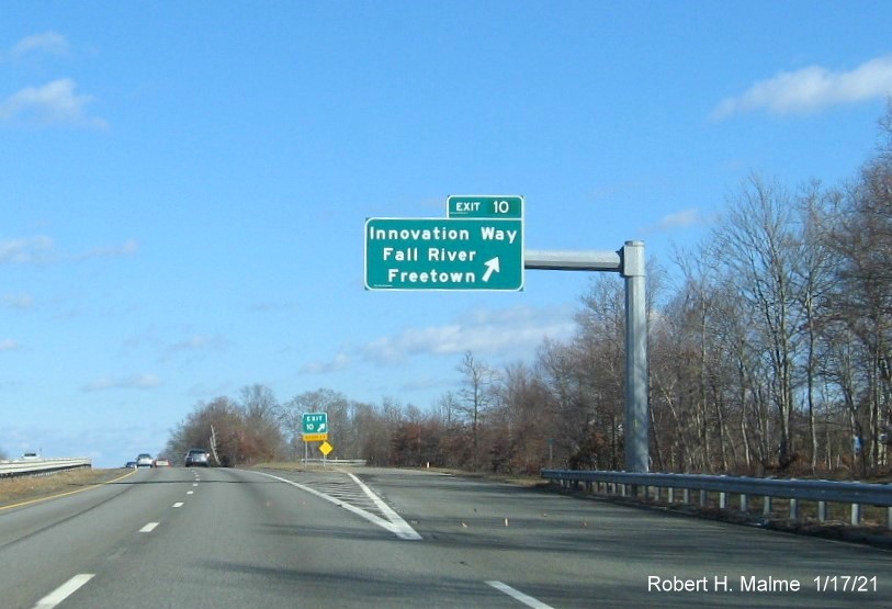 Image of overhead ramp sign for Innovation Way exit with new milepost based exit number and gore sign with new number and yellow Old Exit 8B sign below on MA 24 North in Freetown, January 2021