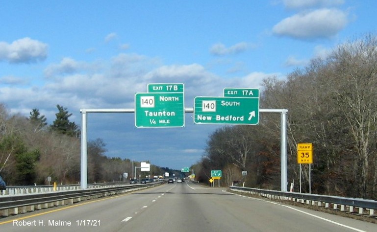 Image of overhead signage at ramp for MA 140 South exit with new milepost based exit numbers gore sign with new number and yellow Old Exits 12 B sign below on MA 24 North in Taunton, January 2021