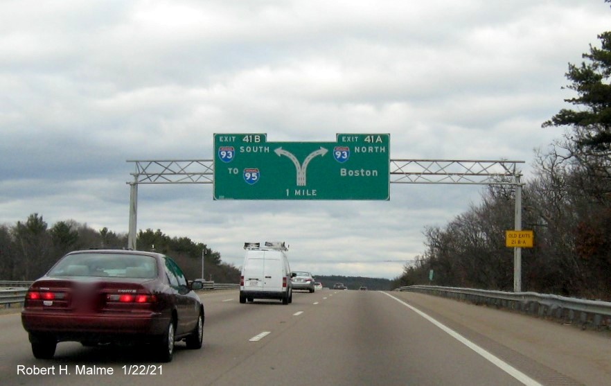 Image of 1 mile advance diagrammatic sign for I-93 exits with new milepost based exit numbers and yellow old exit numbers sign on right support post on MA 24 North in Randolph, January 2021