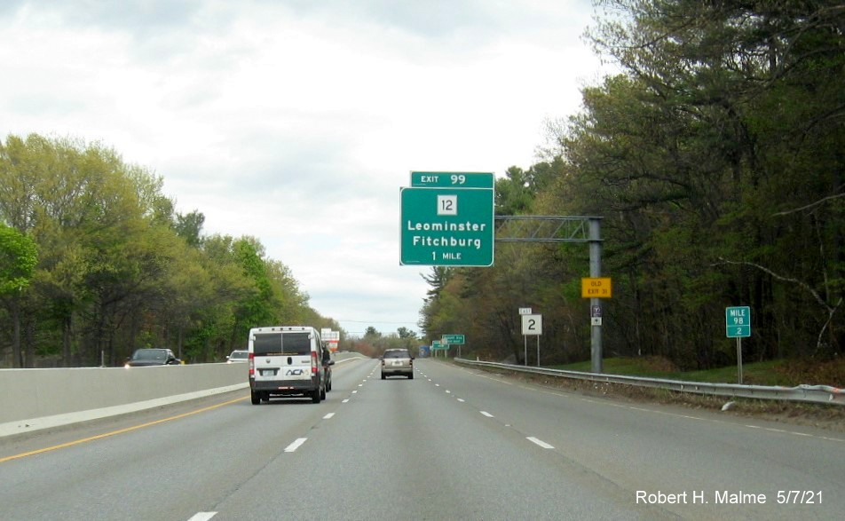 Image of 1 Mile advance overhead sign for MA 12 exit with new milepost based exit number and yellow Old Exit 31 advisory sign on support on MA 2 East in Leominster, May 2021