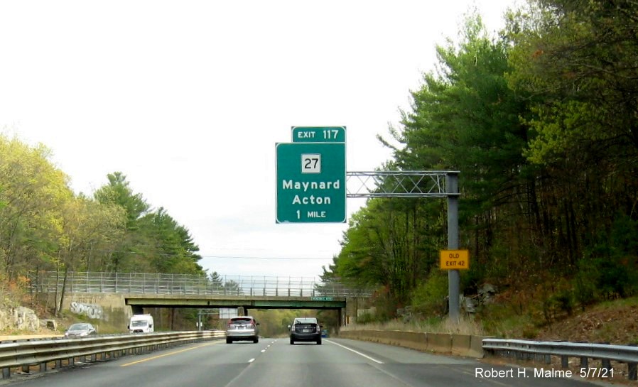 Image of 1 mile advance overhead sign for MA 27 exit with new milepost based exit number and yellow Old Exit 42 advisory sign on support on MA 2 East in Acton, May 2021