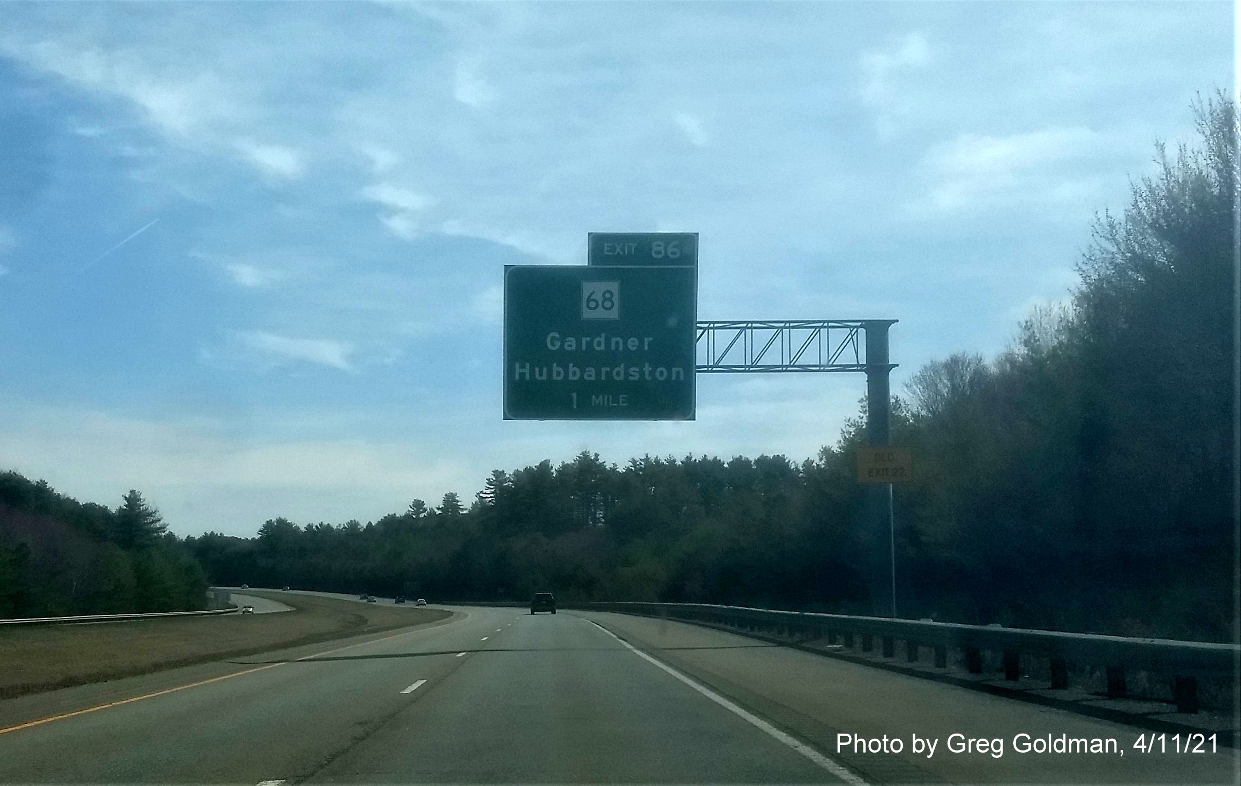 Image of 1 Mile advance sign for MA 68 Exit with new milepost based exit number and yellow Old Exit 22 advisory sign on support on MA 2 East in Gardner, by Greg Goldman, April 2021