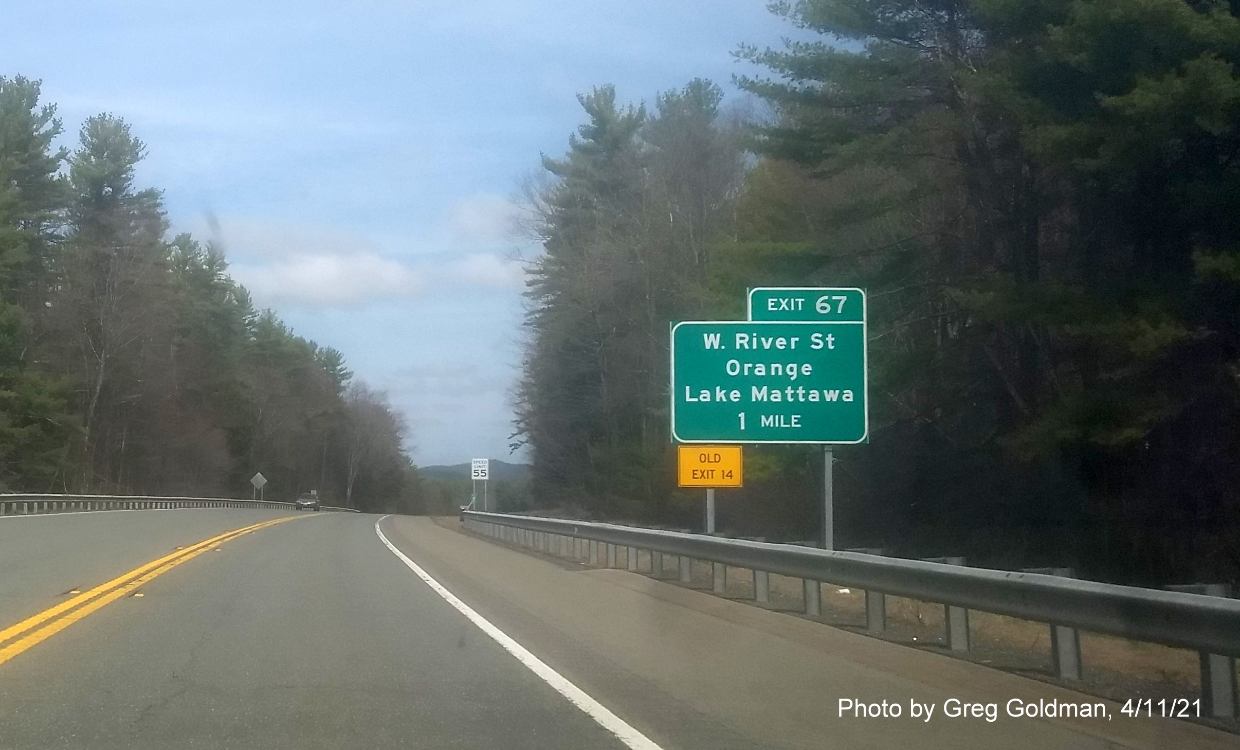 Image of 1 Mile advance sign for West River Street exit with new milepost based exit number and yellow Old Exit 14 sign on left support on MA 2 West in Orange, by Greg Goldman, April 2021