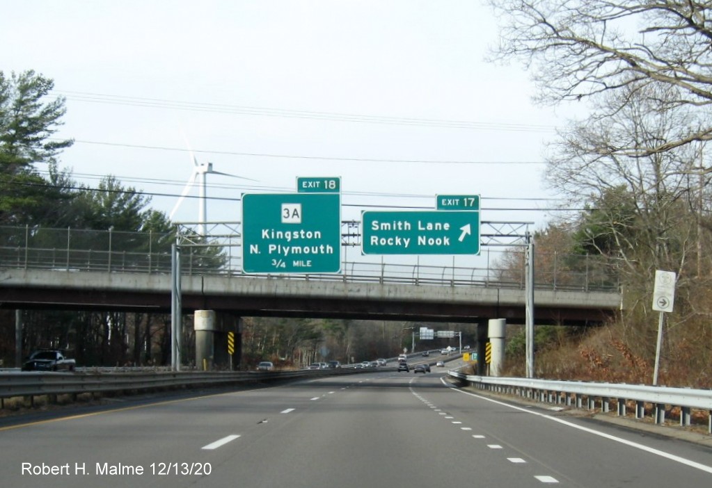 Image of overhead signs at ramp to Smith Lane exit with new milepost based exit numbers on MA 3 North in Kingston, December 2020